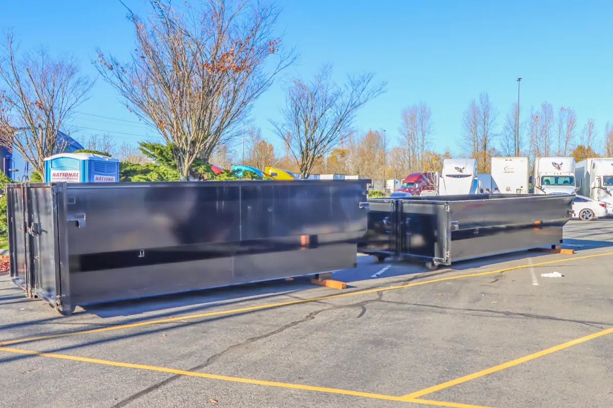 Professional dumpster rental service with roll-off container on residential driveway in Dyersburg